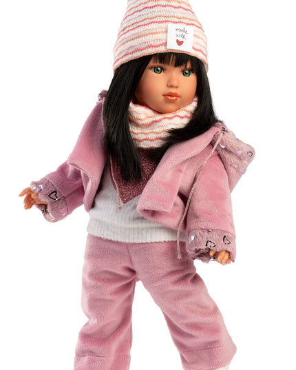 Doll wearing a pink outfit with a matching hat on a white background