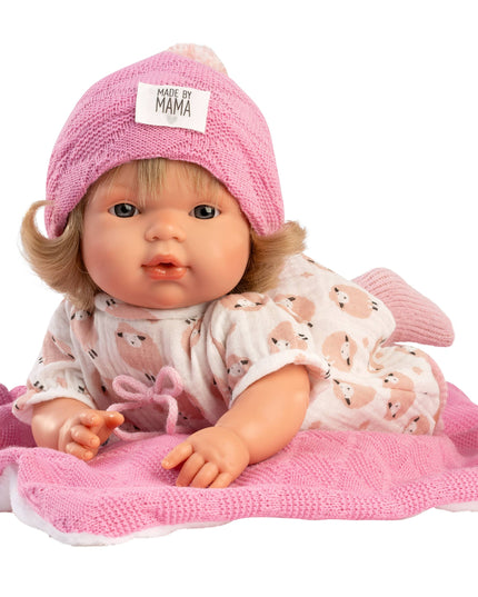 Baby doll with pink outfit and hat on a white background