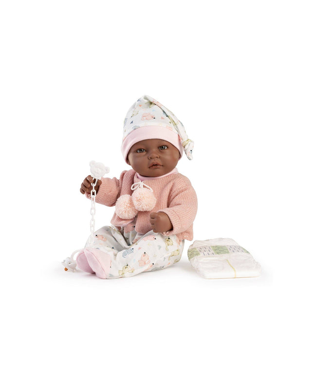 Baby doll in pink outfit with pacifier and blanket on white background