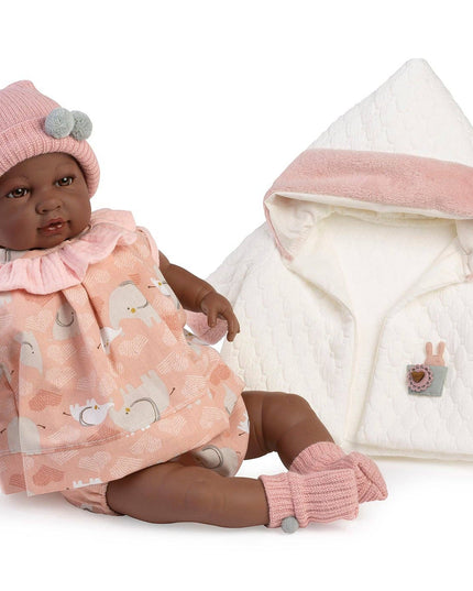 Baby doll with pink outfit and white jacket on a white background