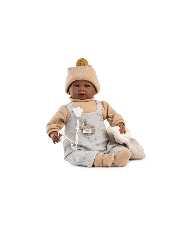 Baby doll with gray overalls and beige hat on a white background