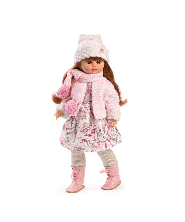 Doll wearing a pink winter outfit with a coat, scarf, hat, and boots on a white background