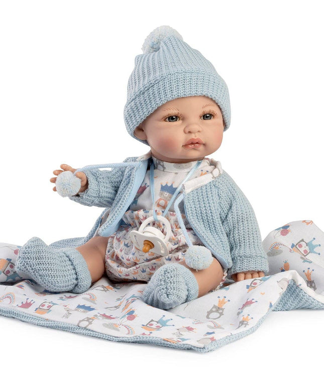 Baby doll in blue outfit and hat on a white background
