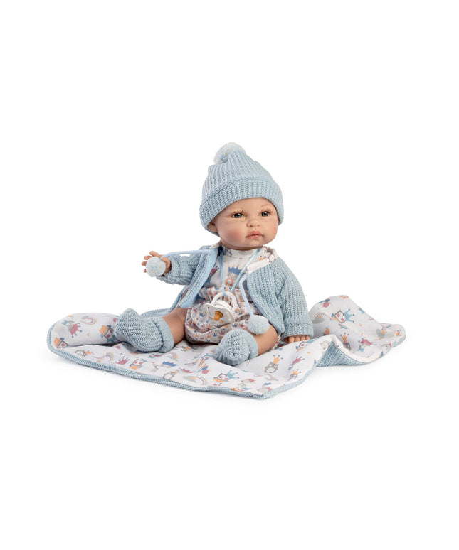 Baby doll in blue outfit and hat on a white background