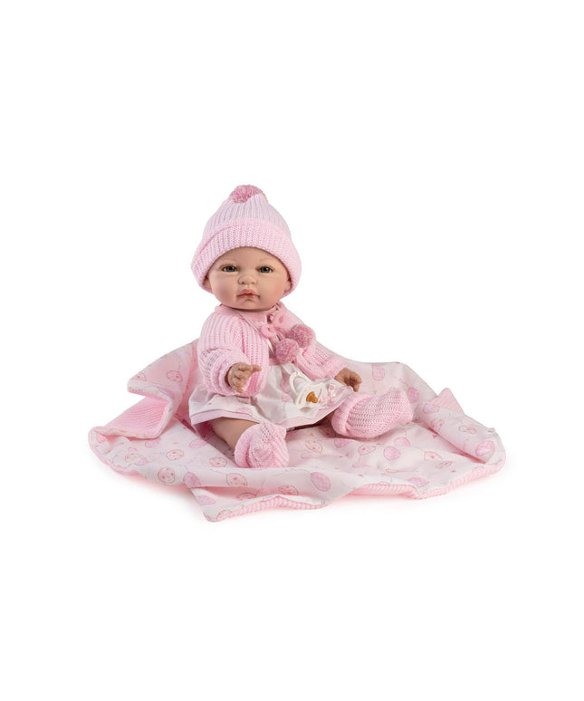 Baby doll in pink outfit with matching hat and blanket on a white background