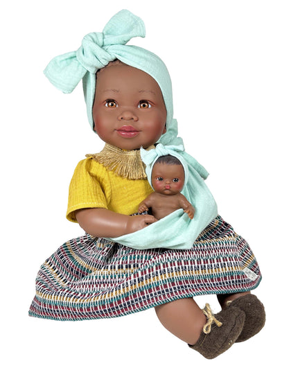Doll holding a smaller doll with a colorful dress and headband on a white background