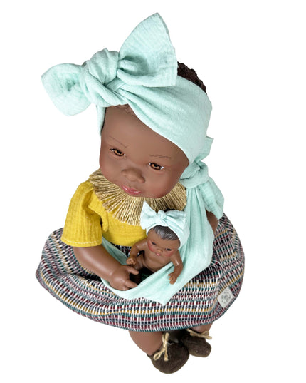 Doll with a baby in a basket on a white background