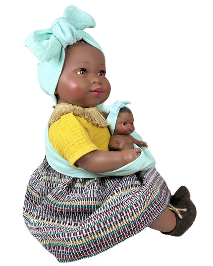 Doll holding a smaller doll with a colorful outfit and headscarf on a white background