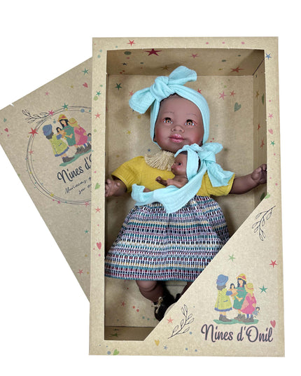Baby doll in a decorative box with 'Nines d'Onil' branding