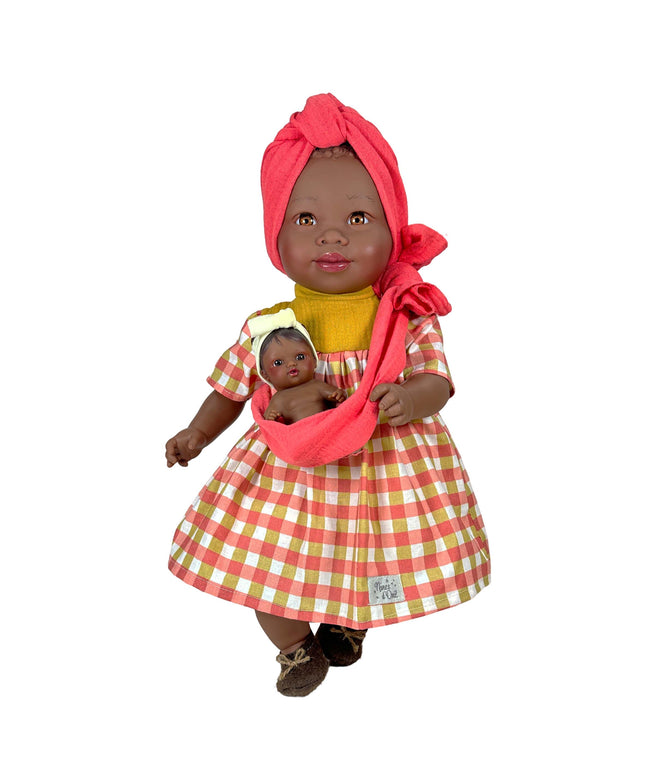 Doll wearing a red checkered dress holding a smaller doll on a white background
