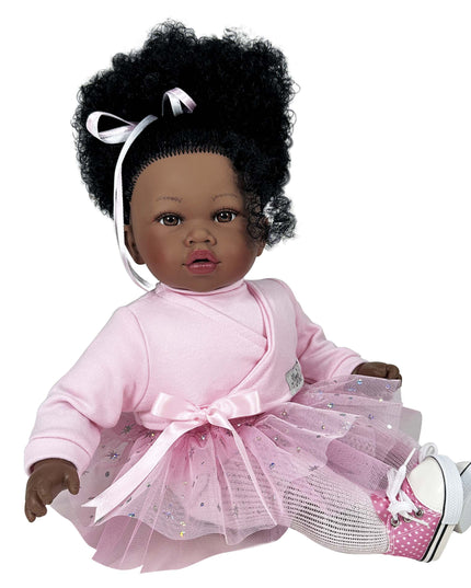 Doll with curly hair wearing a pink outfit on a white background