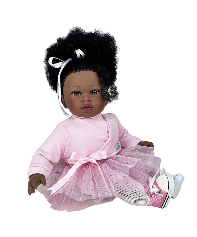 Doll with curly hair wearing a pink outfit on a white background