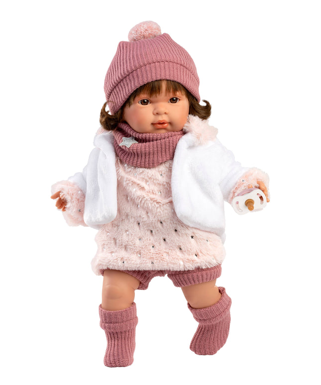 Doll wearing a pink outfit with a hat, scarf, and boots on a white background