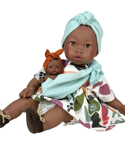 Doll holding a baby doll with a white background