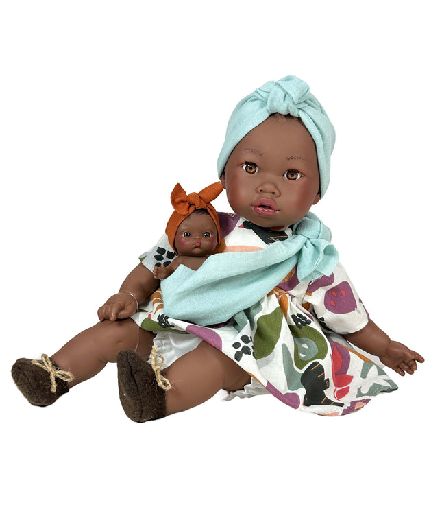 Doll holding a baby doll with a white background