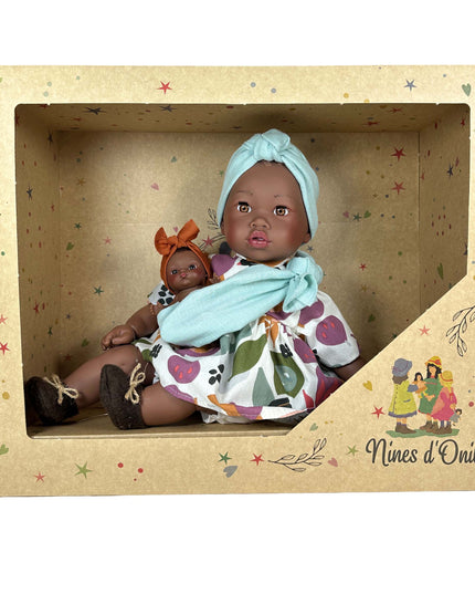 Baby doll in a decorative box with 'Nines d'Onil' branding