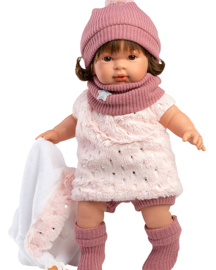 Doll wearing a pink outfit with a hat, scarf, and boots on a white background