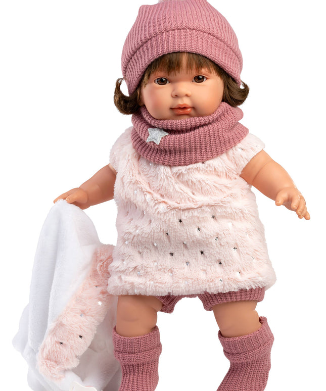 Doll wearing a pink outfit with a hat, scarf, and boots on a white background