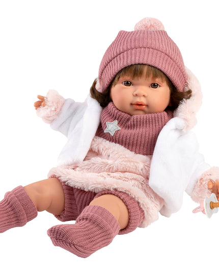  Doll in pink winter outfit with hat and scarf on a white background