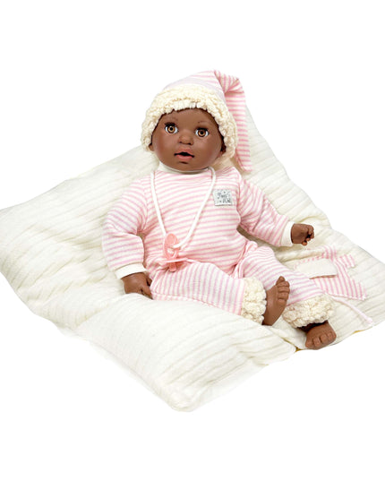 Baby doll in pink outfit with white blanket on a white background