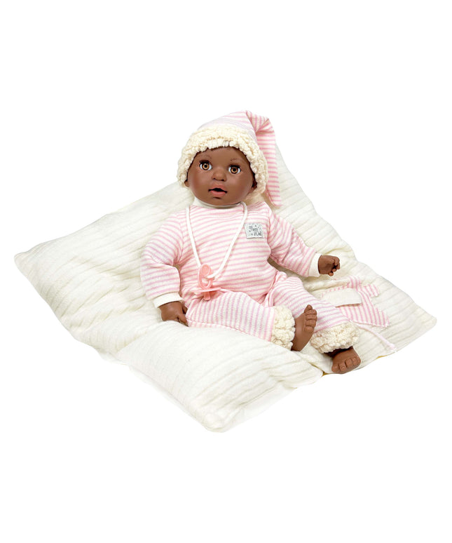 Baby doll in pink outfit with white blanket on a white background
