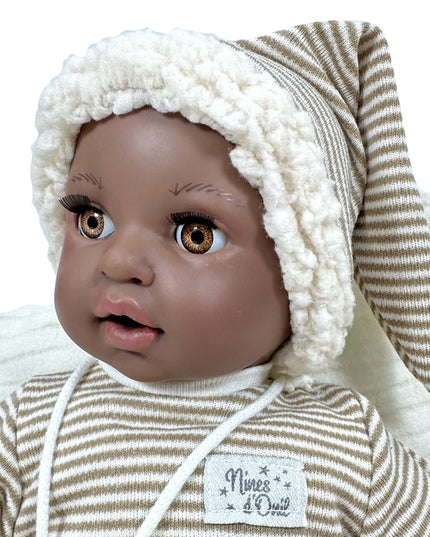Baby doll with a striped outfit and white bonnet on a white background