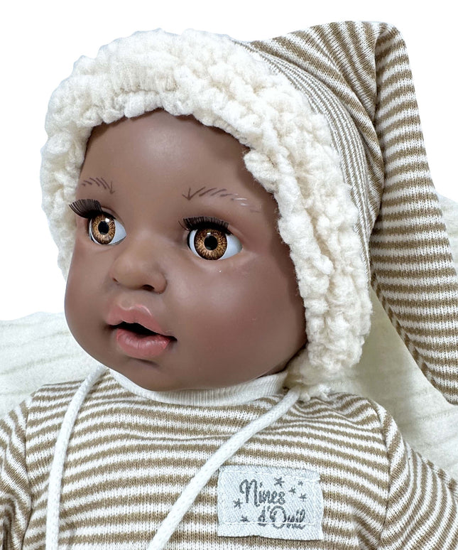 Baby doll with a striped outfit and white bonnet on a white background