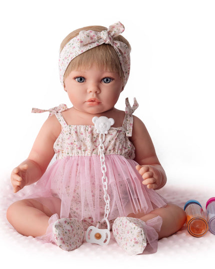Baby doll in a pink outfit with a headband on a white background