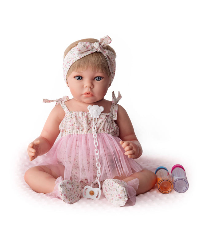 Baby doll in a pink outfit with a headband on a white background