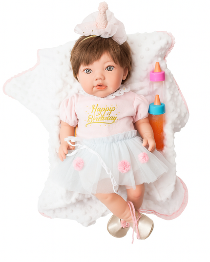 Baby doll in a birthday-themed outfit with a cake on a white background