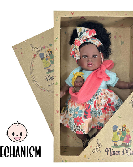 Doll in a decorative box with 'Nines d'Onil' branding, featuring a colorful outfit and headband.