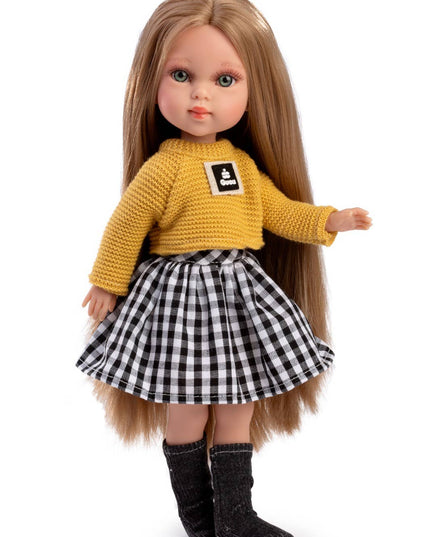 Doll wearing a yellow sweater with a logo and a black and white checkered skirt on a white background