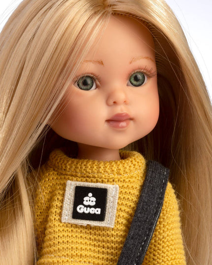 Doll wearing a yellow sweater with a Gucci logo on a white background