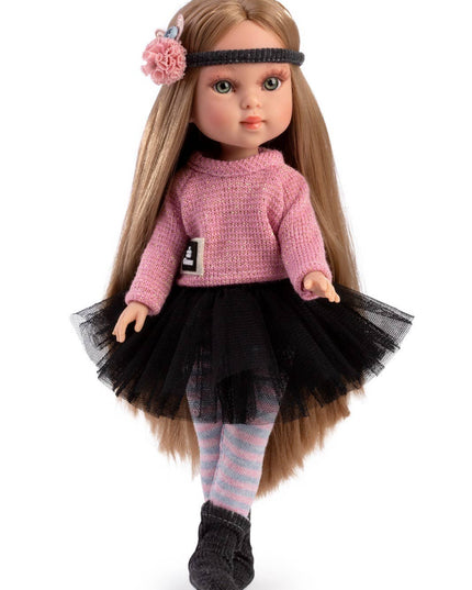 Doll with long brown hair wearing a pink sweater and black tutu on a white background