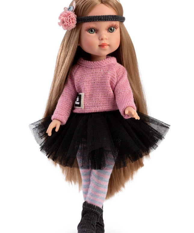 Doll with long brown hair wearing a pink sweater and black tutu on a white background