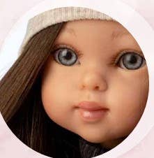 Close-up of a doll with detailed facial features and dark hair.