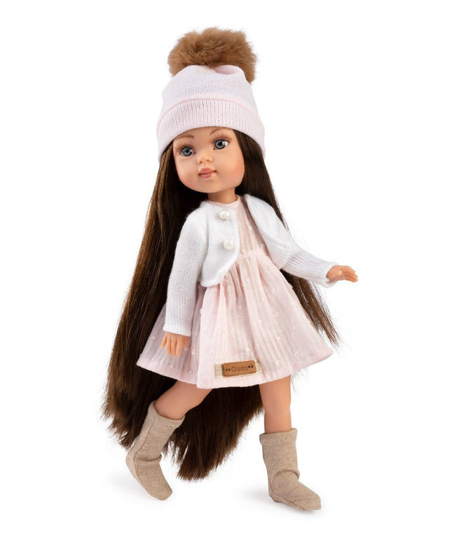 Doll with long brown hair wearing a white outfit, beige boots, and a white hat with a brown pom-pom on a white background.