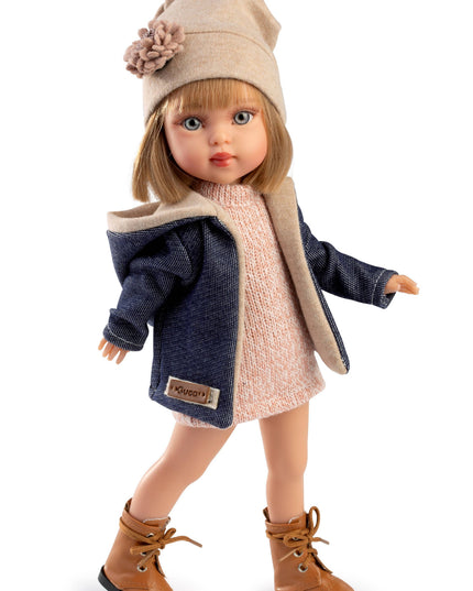 Doll wearing a coat, hat, and boots on a white background