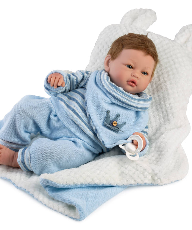 Baby doll in a blue outfit with a white blanket on a white background