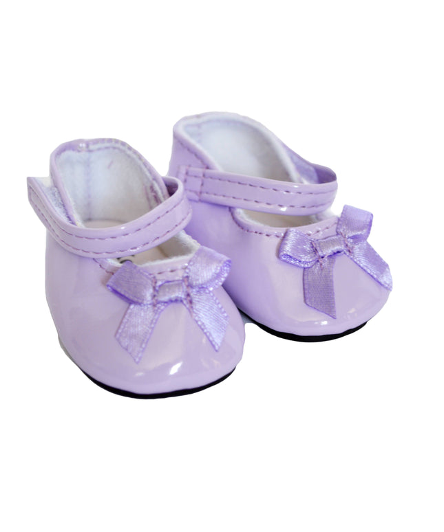Pair of purple shoes with bows on a white background