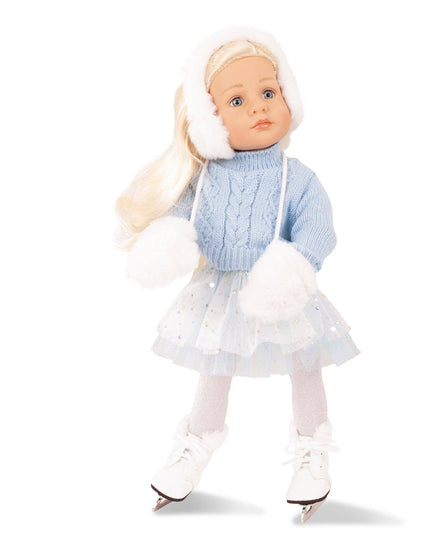 Doll in winter outfit with blue sweater and white skirt on a white background