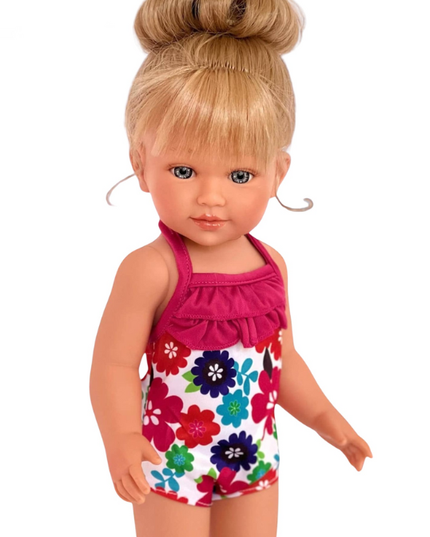 Doll wearing a floral swimsuit with a pink top on a white background