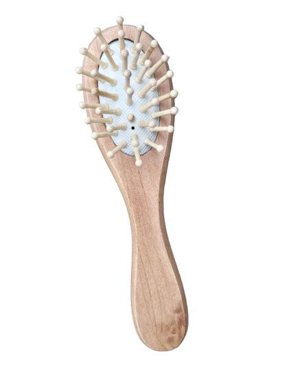 Wooden hairbrush with bristles on a wooden surface