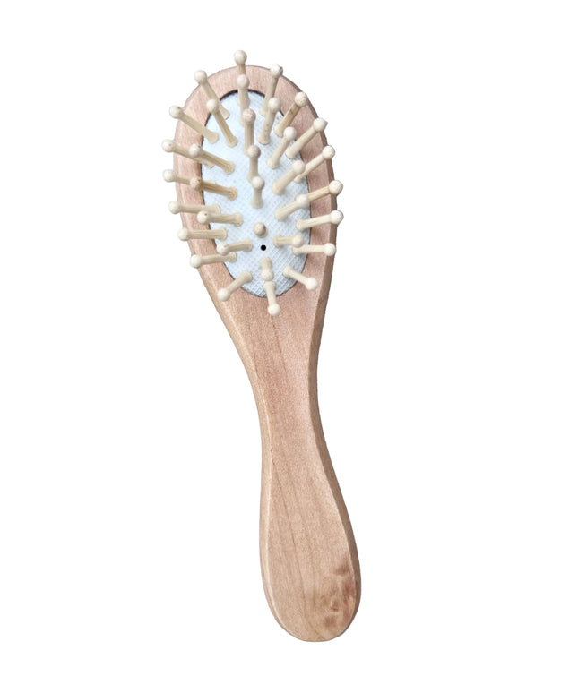 Wooden hairbrush with bristles on a wooden surface