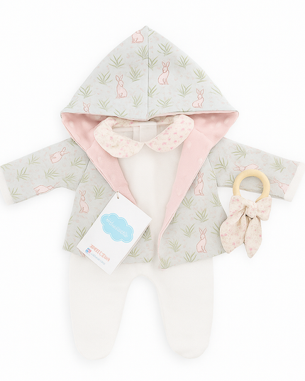 Baby hooded cloak with pink lining and a teething ring on a white background