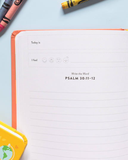 Notebook with a page titled 'Today is' and 'PSALM 30:11-12', surrounded by crayons on a light blue background.