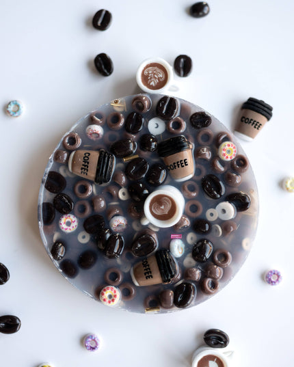 Round resin coaster with coffee-themed decorations on a white background