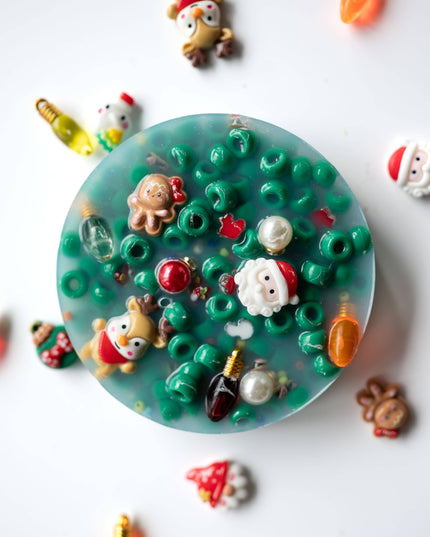 Decorative resin coaster with small figurines on a white background