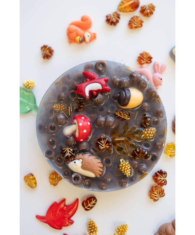 Decorative soap with animal figurines and nature elements on a white background
