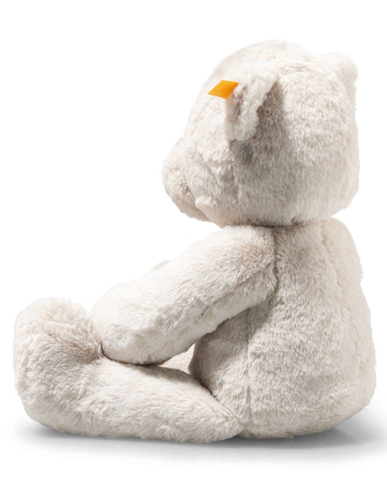 White plush toy with a yellow beak on a white background
